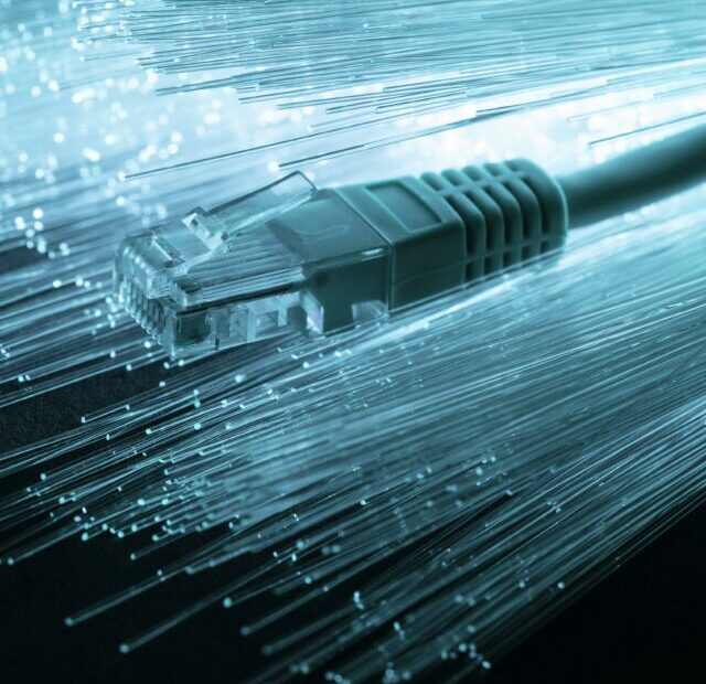 cropped-blue-optic-fiber-with-ethernet-cable.jpg
